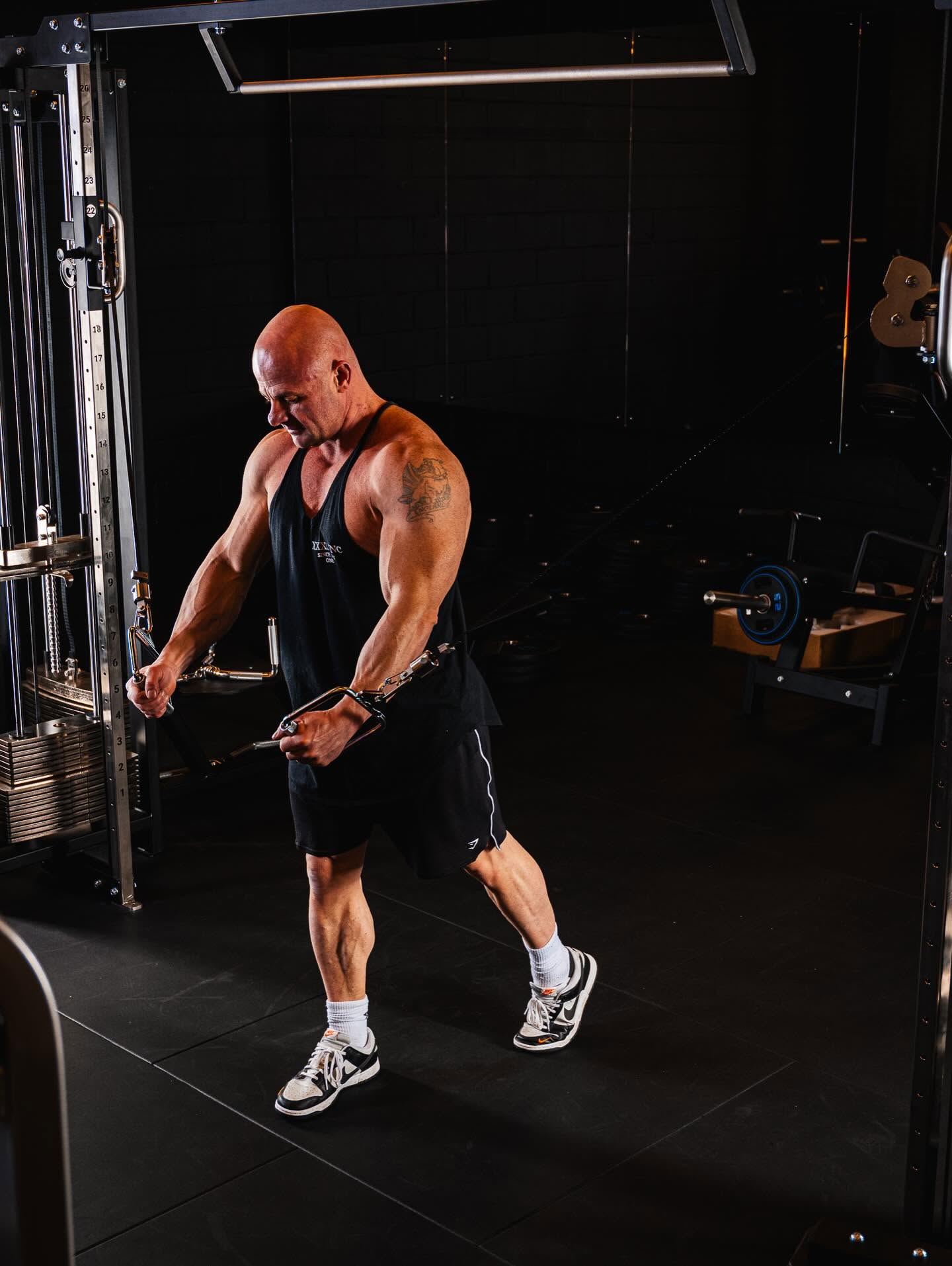 A dedicated Elite Physiques member training on the cable machine inside the gym